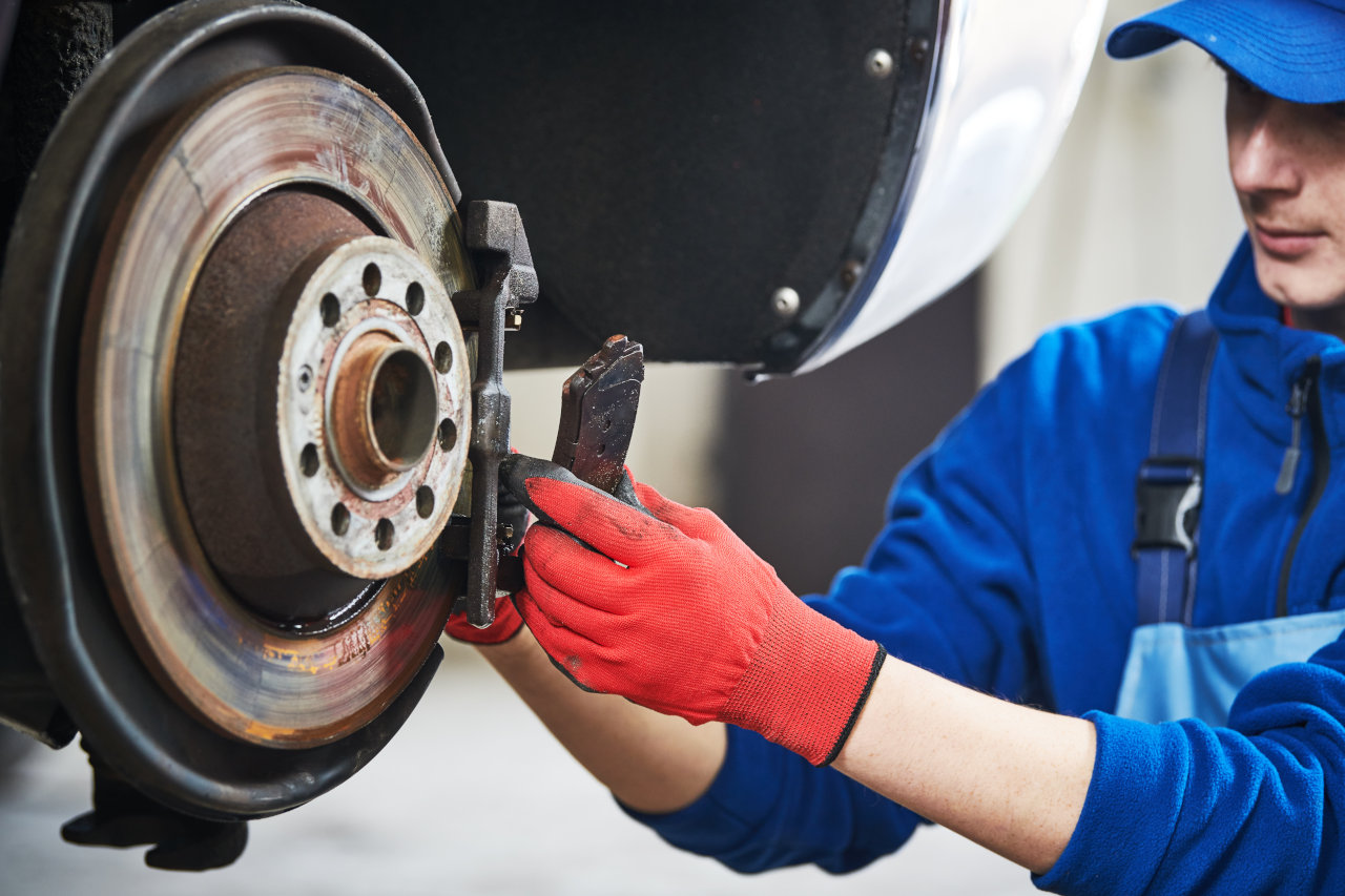 Automobile brake pads replacement in car repair shop or garage